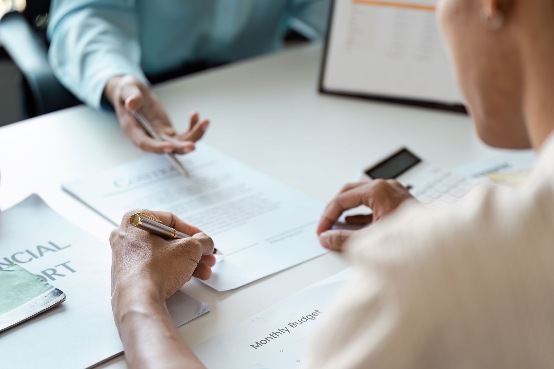 Young Couple Engaged in Financial Planning and Budgeting and signature with Documents and Adviser Financial